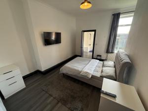 a small bedroom with a bed and a mirror at Plessey Road LARGE 5 Bed, 2 Bath, Contractors NEW in Cowpen