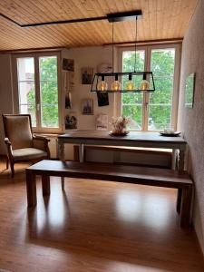 a living room with a bench and a chandelier at Simple flat 72 m2 in the centre of Burgdorf with private parking in Burgdorf