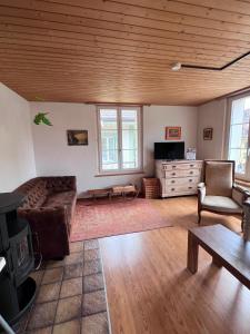 a living room with a couch and a table at Simple flat 72 m2 in the centre of Burgdorf with private parking in Burgdorf