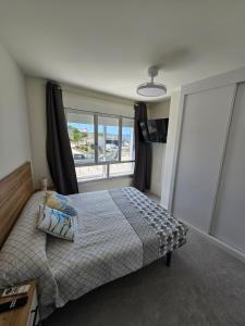 a bedroom with a bed and a large window at Apartamentos Casa Albino in Sanxenxo