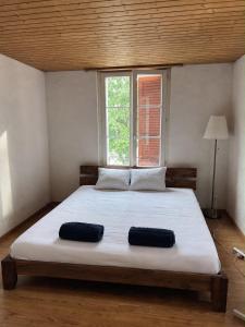 a bedroom with a large bed with two pillows on it at Simple flat 72 m2 in the centre of Burgdorf with private parking in Burgdorf