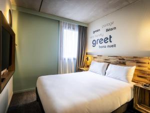 a hotel room with a bed and a television at Greet Hôtel Orthez Bearn in Orthez +69 photos