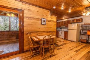 a kitchen with a table and chairs in a cabin at Dragonfly Cabin in Bryson City