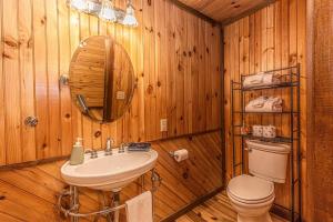 a wooden bathroom with a sink and a toilet at Dragonfly Cabin in Bryson City +66 photos