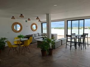 a living room with a couch and a table and chairs at Playa del Carmen - Playaquerida in Playa del Carmen