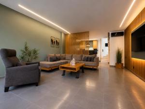 a living room with couches and a coffee table at Olea Luxury Living in Nea Fokea