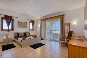 a bedroom with a bed and a desk and a table at D View 4 You in Mellieħa +90 photos