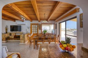 a kitchen and dining room with a table and chairs at D View 4 You in Mellieħa