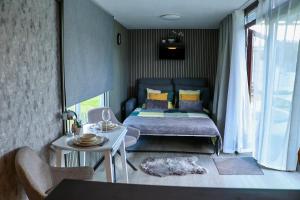 a small bedroom with a bed and a table at ''Zunds'' Camping house in Riga