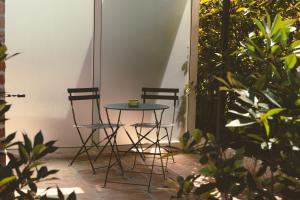 a small table and two chairs on a patio at La Ruota Rooms in Casalgrande