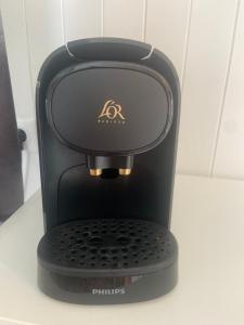 a black coffee maker sitting on a counter at Le wagon roulotte in Thorigny-sur-Marne