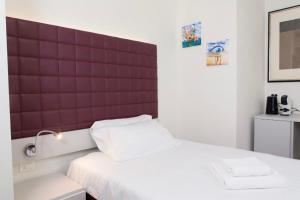 a bed with a red headboard in a room at La Ruota Rooms in Casalgrande