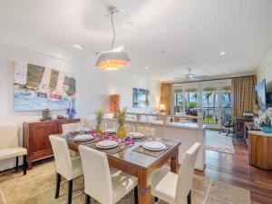 a dining room and living room with a table and chairs at 3-Bed Villa 309 at Turtle Bay in Kahuku