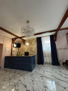 a living room with a chandelier and a marble floor at Готель Гайсин «Тіроль» in Haysyn