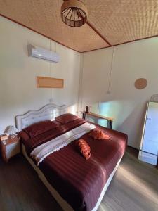 a bed in a bedroom with a dog laying on it at สะปันไลฟ์ in Ban Huai Ti