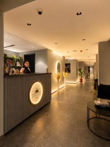 a woman standing at a bar in a lobby at The Sign Highlight Hotel in Bodrum City +43 photos