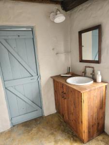 a bathroom with a sink and a sliding door at From Valle Hideaway in Tankwa in Sutherland