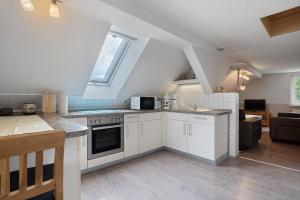 a kitchen with white cabinets and a window at Ferienwohnung 1 in Gribow