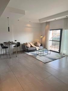 a living room with a couch and a table at QUATTRO-Sky Suites in Accra
