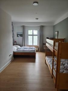 a bedroom with two bunk beds and a window at Ferienhof Möltgen in Bosau