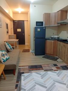 a living room with a couch and a kitchen at Avida Towers Riala, Tower 5 in Cebu City