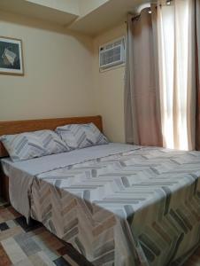 a large bed in a bedroom with a window at Avida Towers Riala, Tower 5 in Cebu City