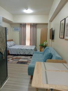 a living room with a couch and a bed at Avida Towers Riala, Tower 5 in Cebu City