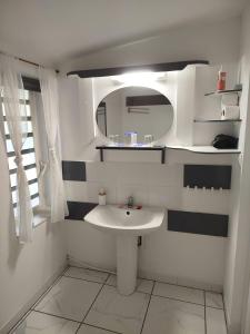 a white bathroom with a sink and a mirror at Kazajany in Terre-de-Haut +53 photos