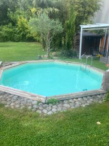 a swimming pool in a yard with a rock border at Le wagon roulotte in Thorigny-sur-Marne