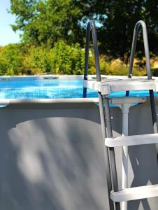 a chair sitting in front of a swimming pool at la cabane mobile in Beyssenac