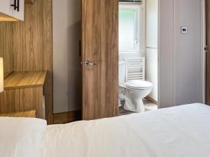 a bedroom with a bed and a toilet and a window at Drover's Den - Uk50090 in Durham +7 photos