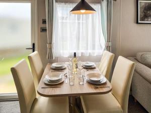 a dining room table with chairs and a table and a dining room at Drover's Den - Uk50090 in Durham