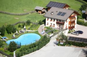 an aerial view of a house with a swimming pool at Lüch de Tor in San Martino in Badia
