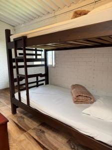 a couple of bunk beds in a room at Cabaña entre Cafetales in Manizales