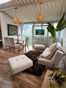 a living room with a table and chairs at Cabaña entre Cafetales in Manizales