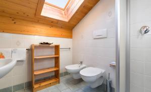 a bathroom with a toilet and a sink at Lüch de Tor in San Martino in Badia +34 photos