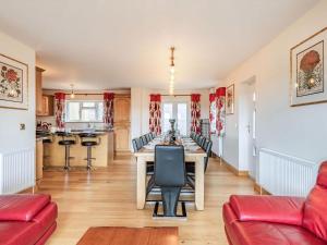 a dining room with a long table and chairs at Paradise in Cinderford