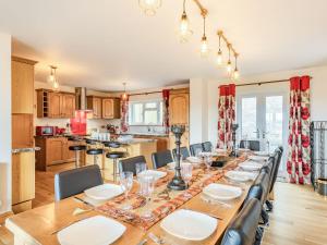 a dining room with a long table and chairs at Paradise in Cinderford +32 photos