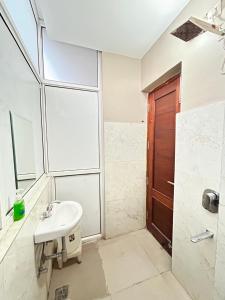 a bathroom with a sink and a shower at Utk 3 in Panchkula +34 photos