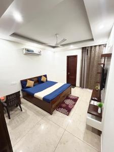 a bedroom with a bed and a desk in it at Utk 3 in Panchkula