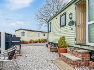 a home with a patio and a house at Oakmere - Uk51989 in Oakmere