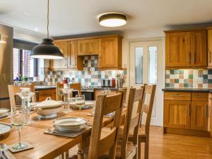 a kitchen with a wooden table and a dining room at Evergreen House in Runswick