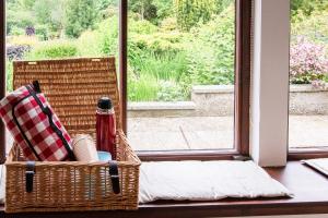 a basket sitting on a table next to a window at Middle Lodge in Mintlaw