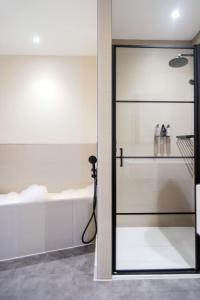 a glass door in a bathroom with a bath tub at School Lane Hotel in Liverpool ONE in Liverpool +16 photos
