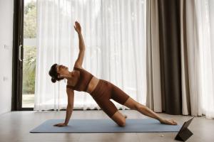 a woman doing a yoga pose on a yoga mat at la Villa des Fleurs in La Bourboule