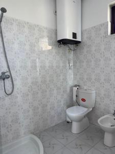 a bathroom with a toilet and a sink at Hill Haven Guesthouse in Domje