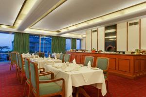 a dining room with tables and chairs and a counter at Clarkes hotel, A grand heritage hotel since 1898 in Shimla