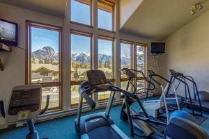 a gym with three elliptical machines and a large window at Whispering Pines in Durango Mountain Resort
