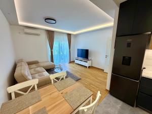 a living room with a couch and a table at Apartmants City Love in Podgorica