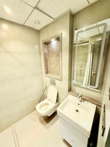 a bathroom with a toilet and a sink at Nova Spira in Noida +25 photos